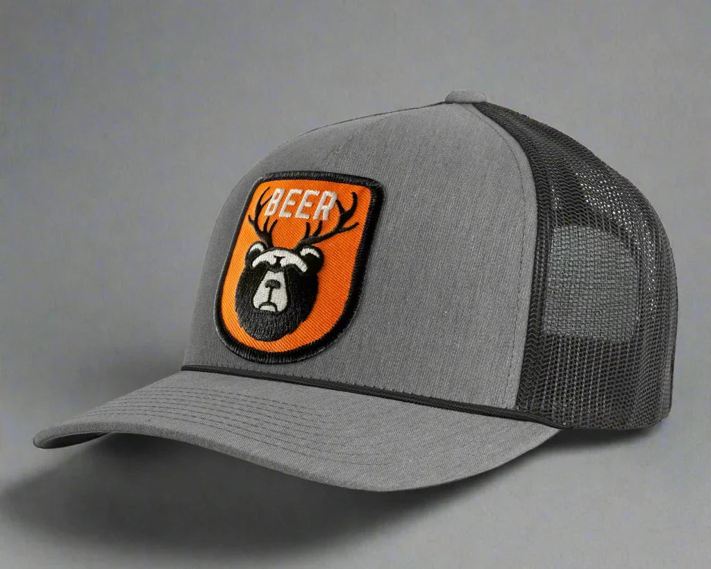 Gray and black trucker hat with orange bear and antlers BEER patch on front