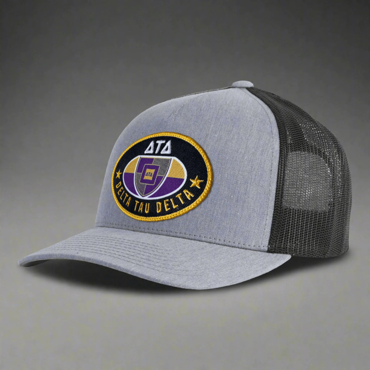 Gray Delta Tau Delta mesh trucker hat with embroidered purple and gold logo patch