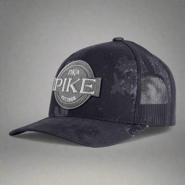 Black camo mesh trucker hat with PIKE embroidered patch, Greek letters, and curved bill