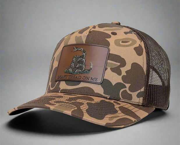 Brown camo trucker hat with mesh back and 'Don't Tread On Me' snake patch on front