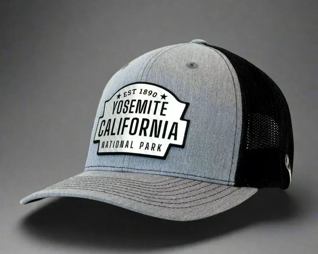 Grey Yosemite California National Park trucker hat with black mesh back on a plain background.