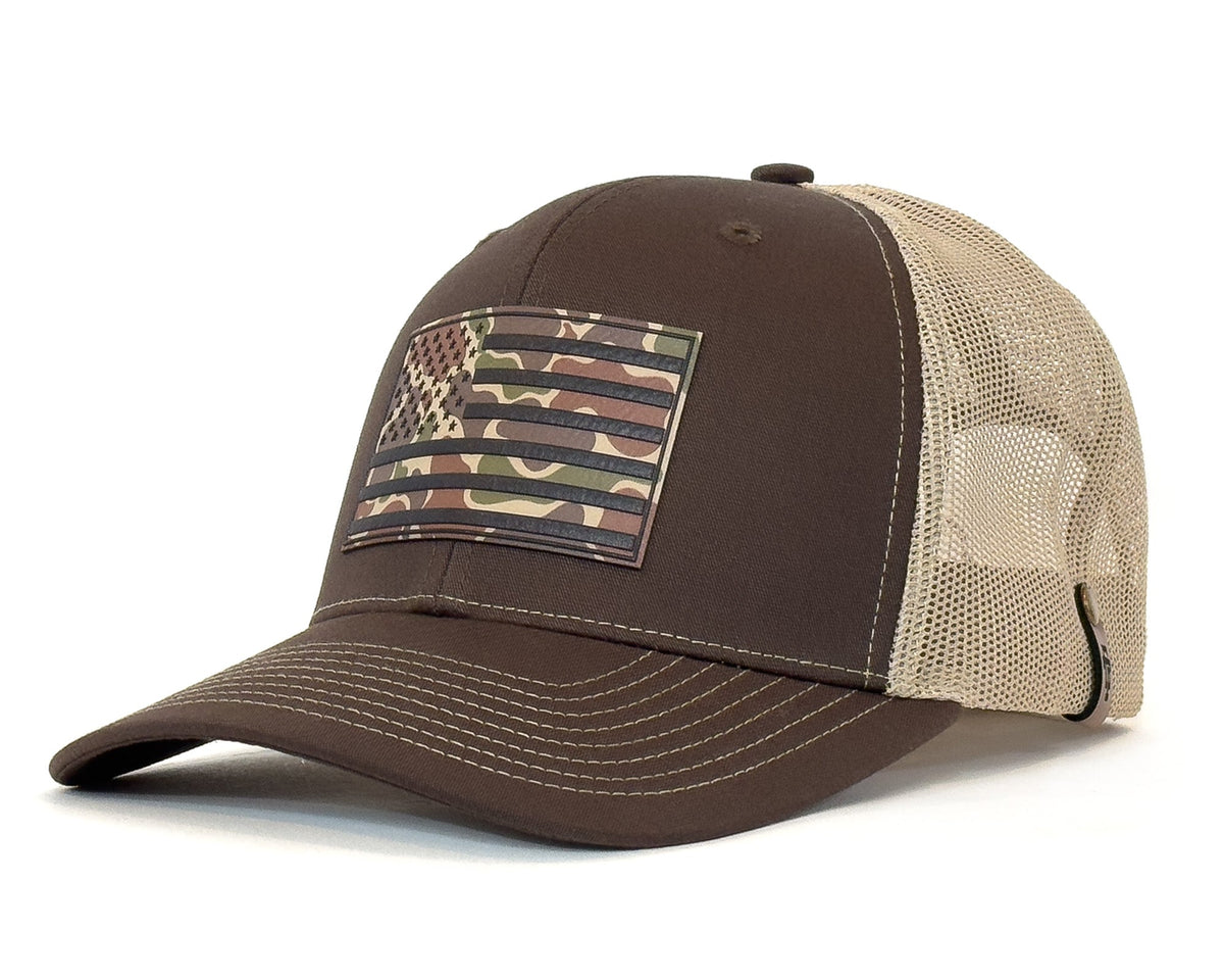 Brown and beige cap with camouflage American flag patch on a white background