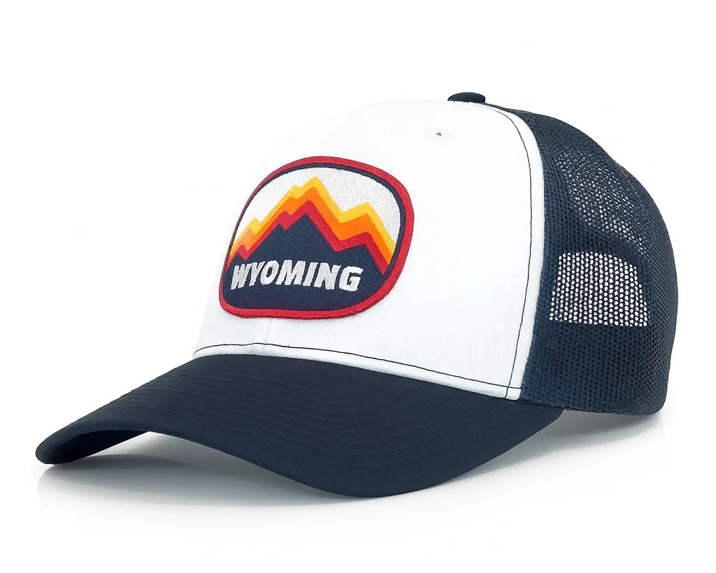 White and navy trucker hat with Wyoming logo on a white background