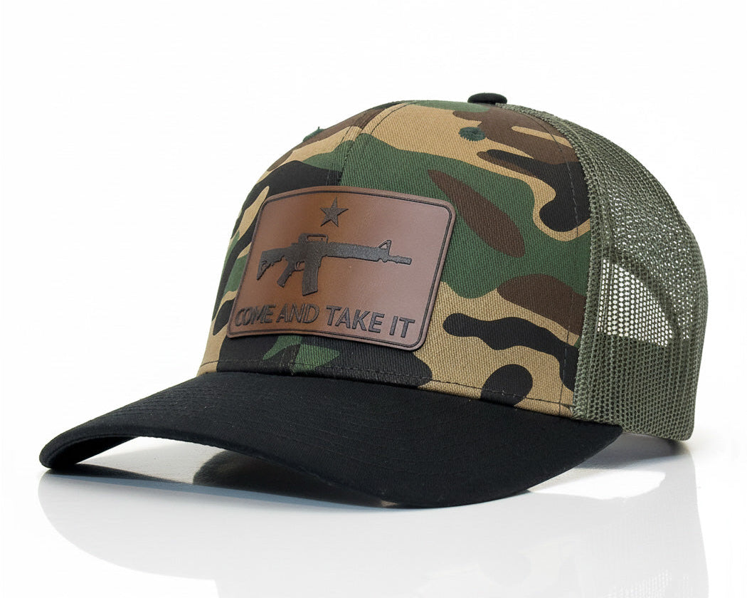 Camouflage baseball cap with leather patch on a white background