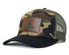 Camouflage baseball cap with a leather patch on a white background