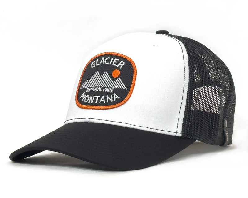 White and black cap with Glacier National Park patch on a white background