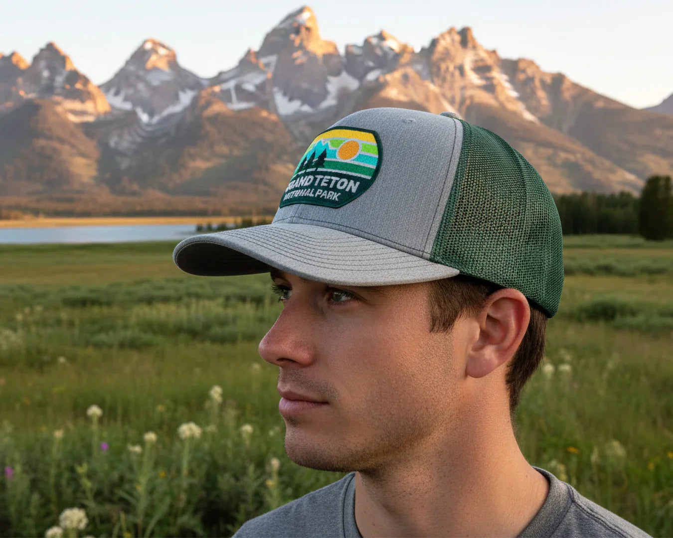Person wearing a National Park Foundation cap with mountains in the background