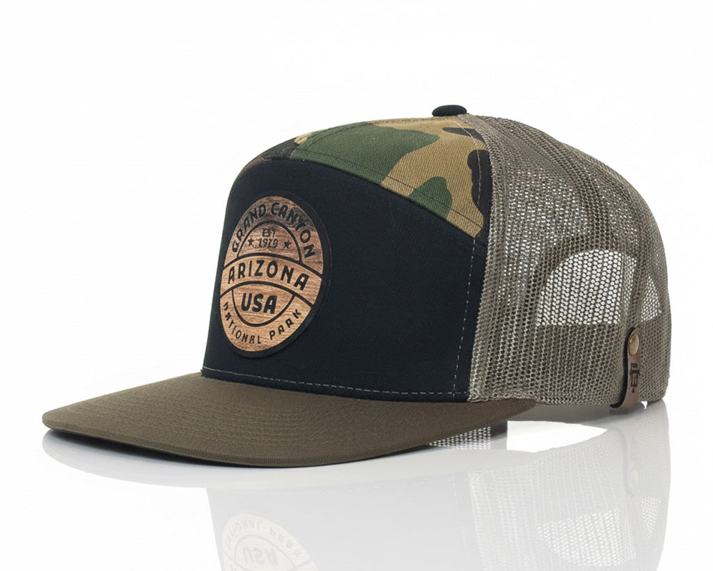 Camouflage and black cap with a patch on a white background