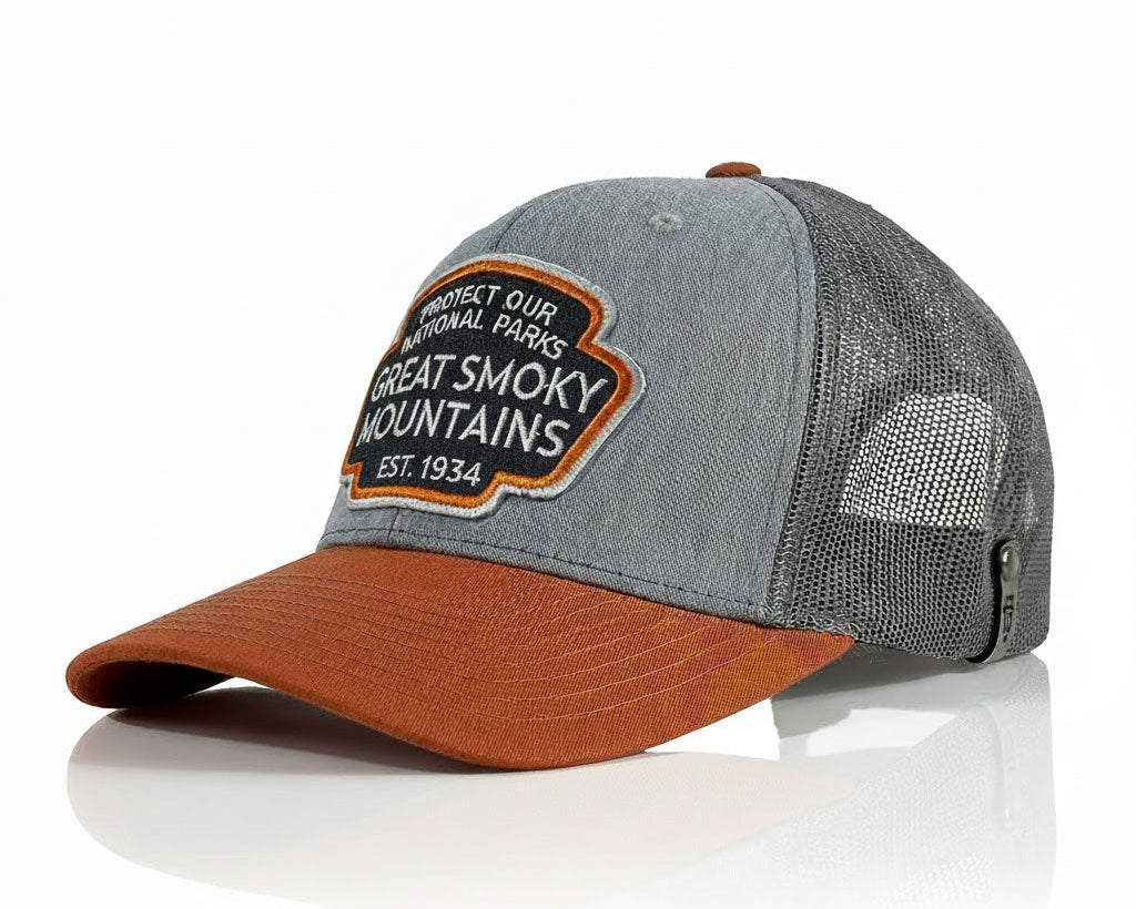A gray and rust-orange trucker cap with a mesh back and a front patch reading 'Great Smoky Mountains National Park'.