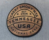 Wooden emblem with 'Great Smoky Mts Tennessee USA' text on a gray background