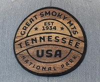 Wooden emblem with 'Great Smoky Mts Tennessee USA' text on a gray background