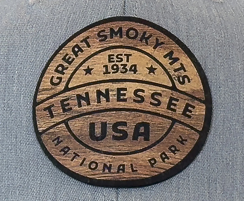 Wooden emblem with 'Great Smoky Mts Tennessee USA' text on a gray background