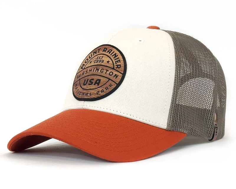 Trucker hat with white front panel, orange bill, and gray mesh back on a white background