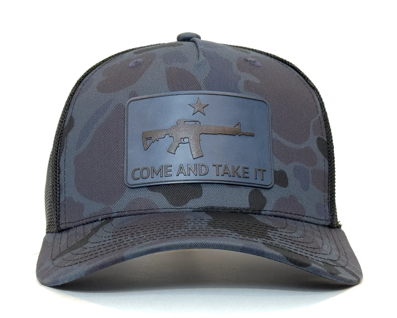 Camouflage cap with 'Come and Take It' patch featuring an AR-15 rifle design on a white background.