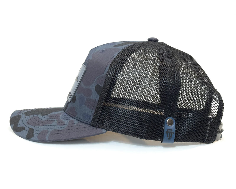 Black and gray camouflage baseball cap with mesh back on a white background