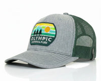 A heather gray and dark green trucker hat with a 'Olympic National Park' patch on the front, set against a clean white background with a subtle reflection.