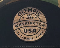 Cap with Olympic Washington USA National Park logo on a dark background