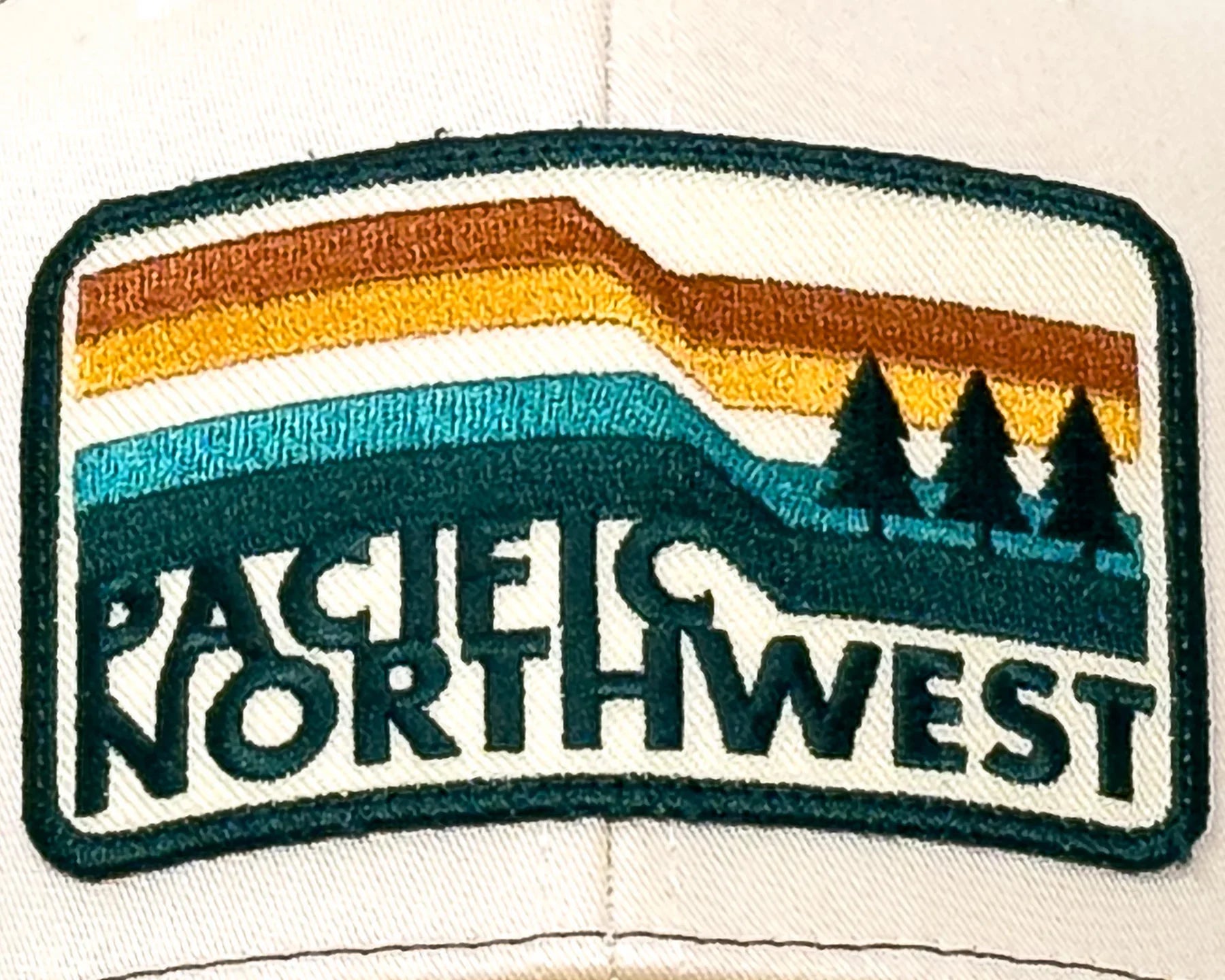 Patch with 'Pacific Northwest' text and mountain design on a cap