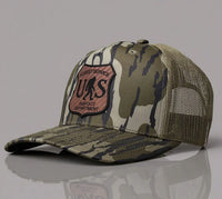 Camouflage cap with a patch on a gray background