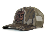 Camouflage cap with a patch on a white background