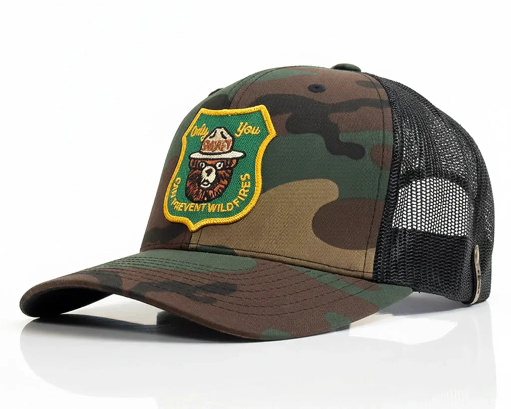 Camouflage baseball cap with a patch on a white background