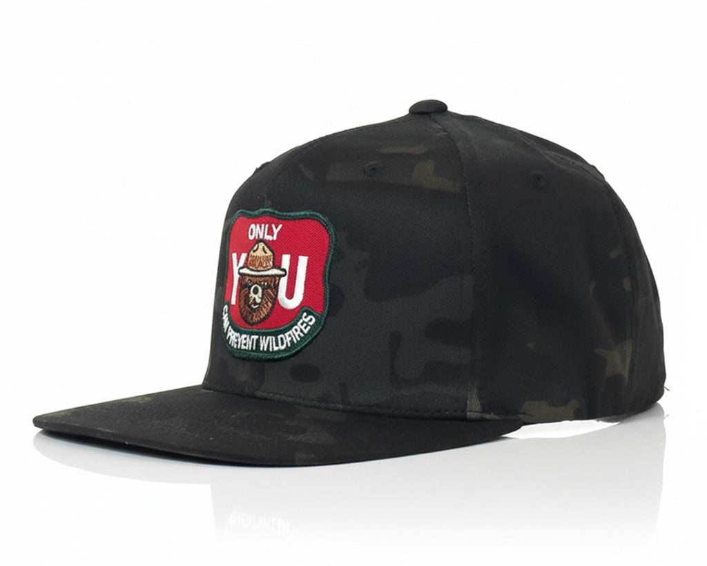 Black camouflage cap with a patch on a white background