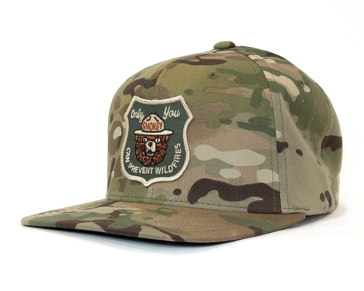 Camouflage cap with a patch on a white background