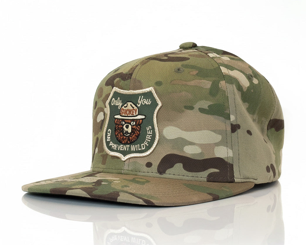 Camouflage cap with a patch on a white background