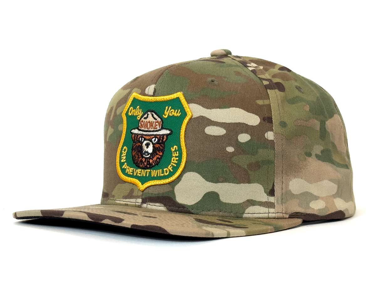 Camouflage cap with a patch on a white background