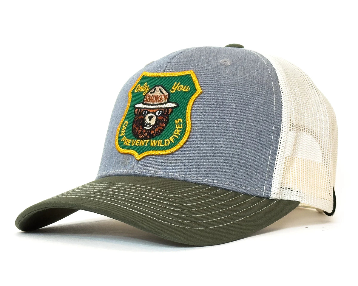 Trucker hat with a patch featuring a bear and text on a white background