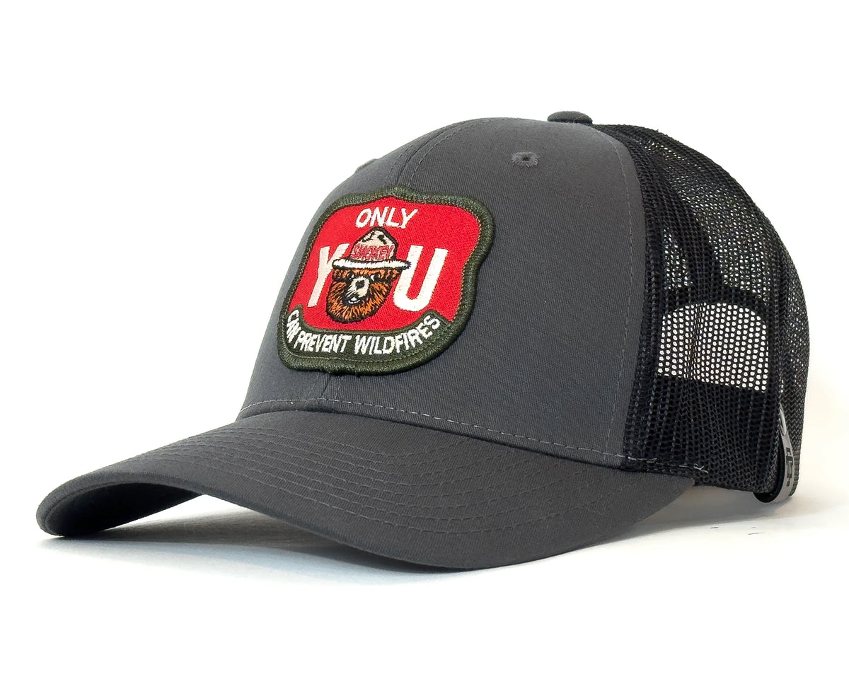 Gray trucker cap with a red and green patch on a white background
