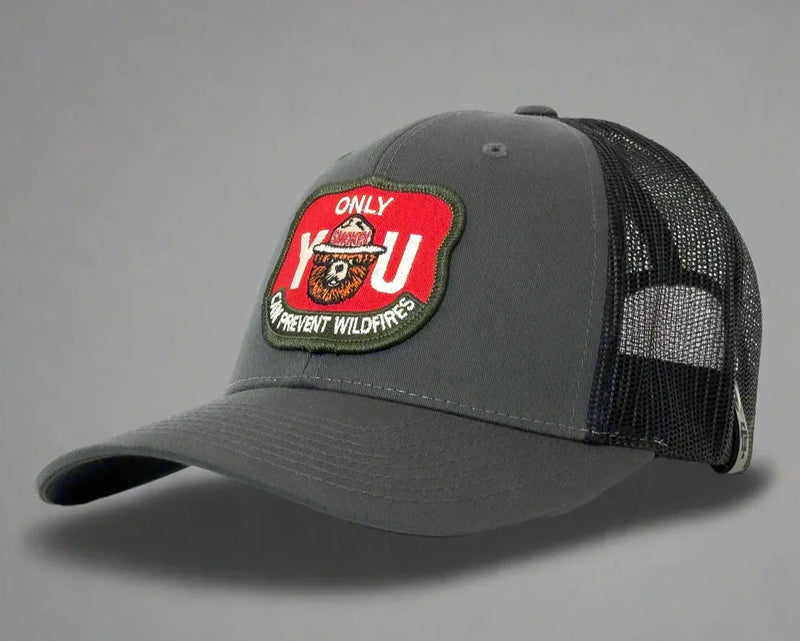 Gray trucker cap with a red and green patch on a gray background