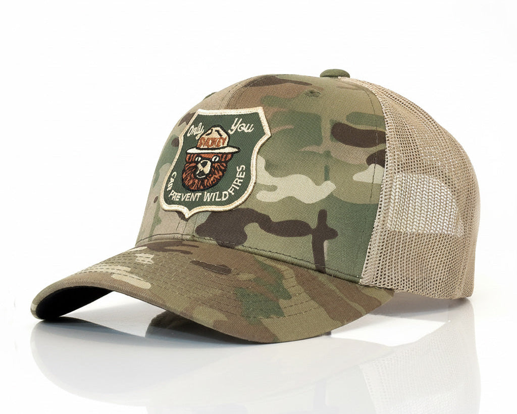 Camouflage baseball cap with a patch on a white background