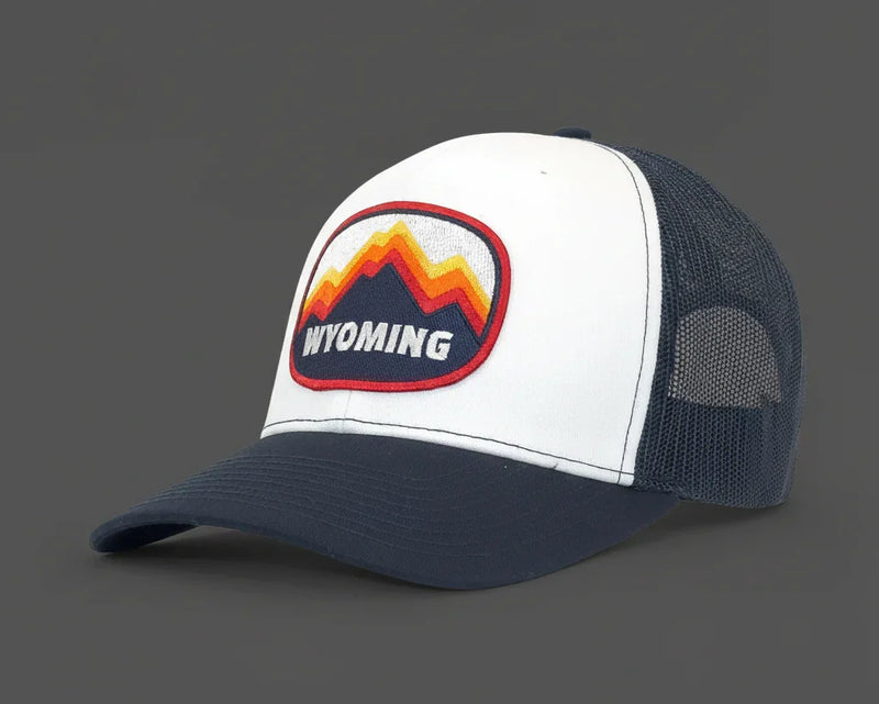 White and navy trucker hat with Wyoming logo on a white background