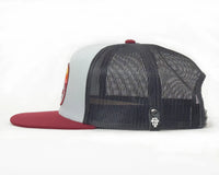 Trucker cap with red brim and mesh back on a white background