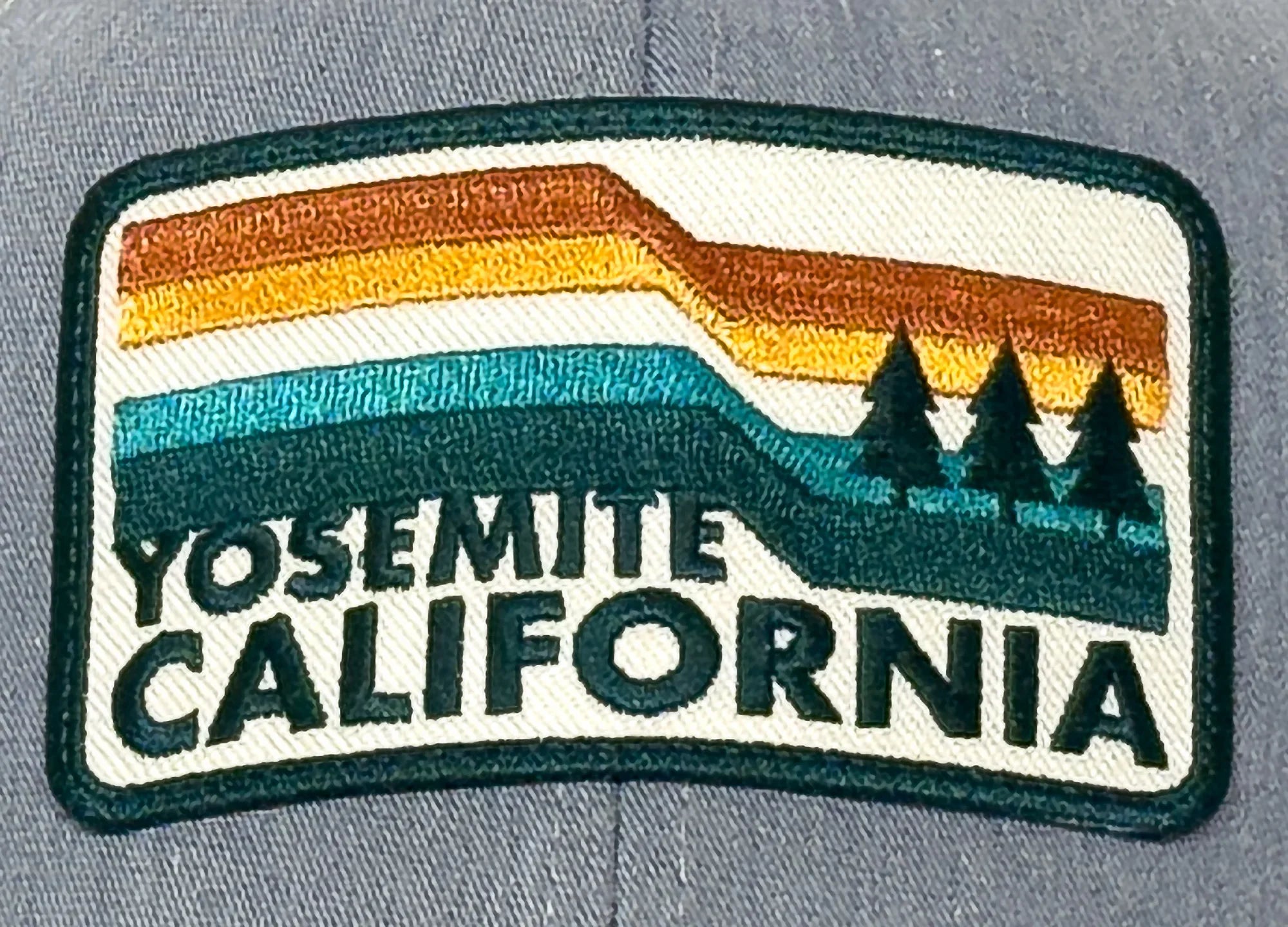 Embroidered patch with 'Yosemite California' text on a gray fabric background