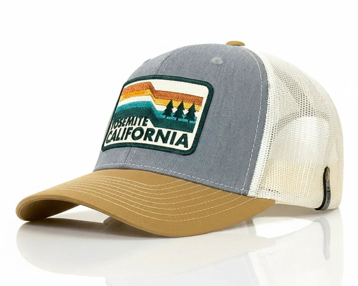A trucker-style baseball cap with a gray front panel, cream mesh back, and tan curved brim. The front panel features an embroidered patch with a rainbow landscape and the text 'Yosemite California'.