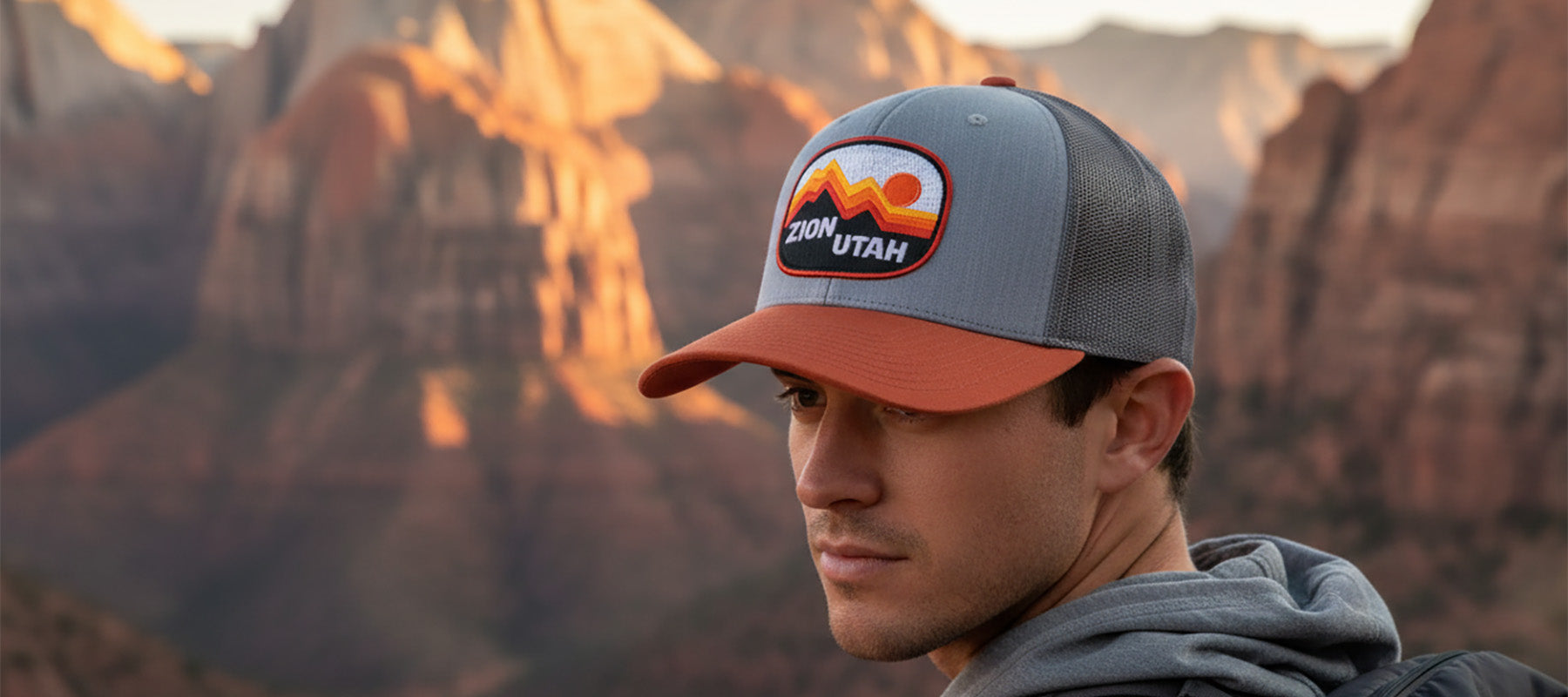 Person wearing a Zion Utah cap with desert landscape in the background
